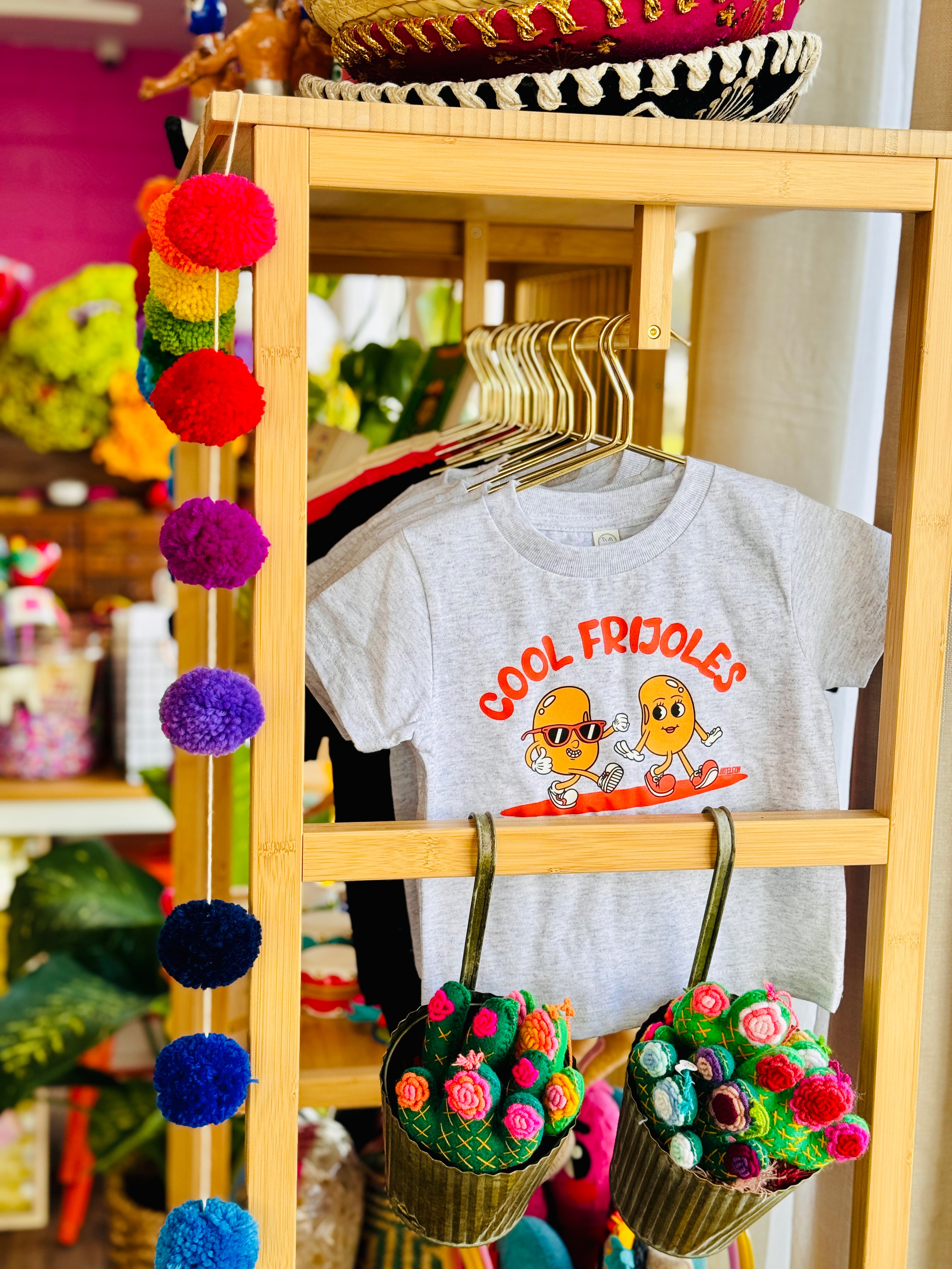 Photo of children's apparel featuring a fun design which reads "Cool Frijoles"