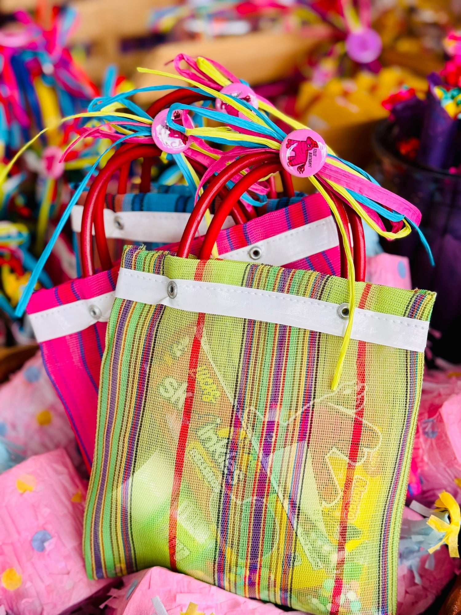 Photo of colorful woven mercado bags containing mexican candy, stickers, & confetti